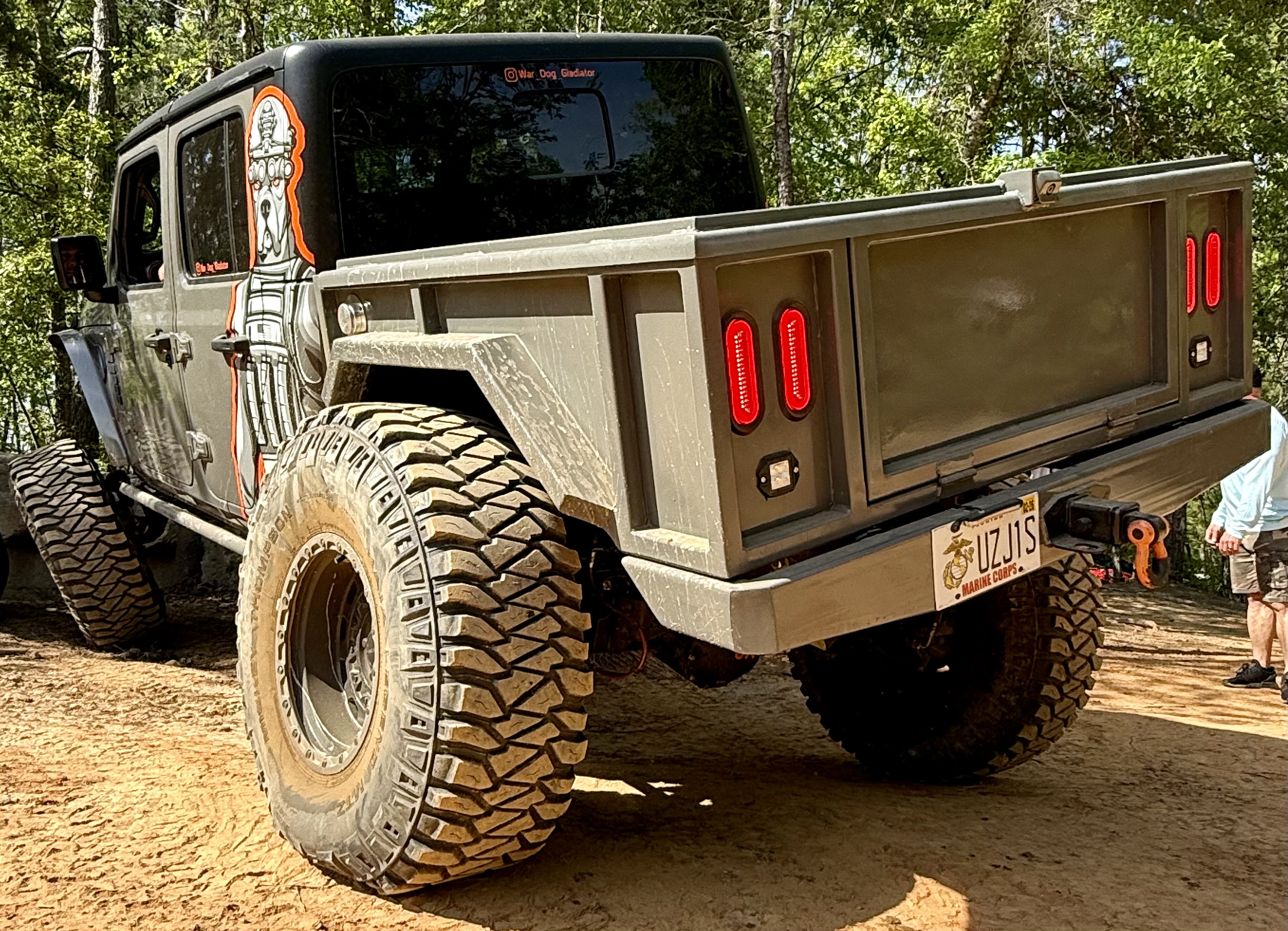 War Dog M1 bed on muddy trail - rear view with dusty tires